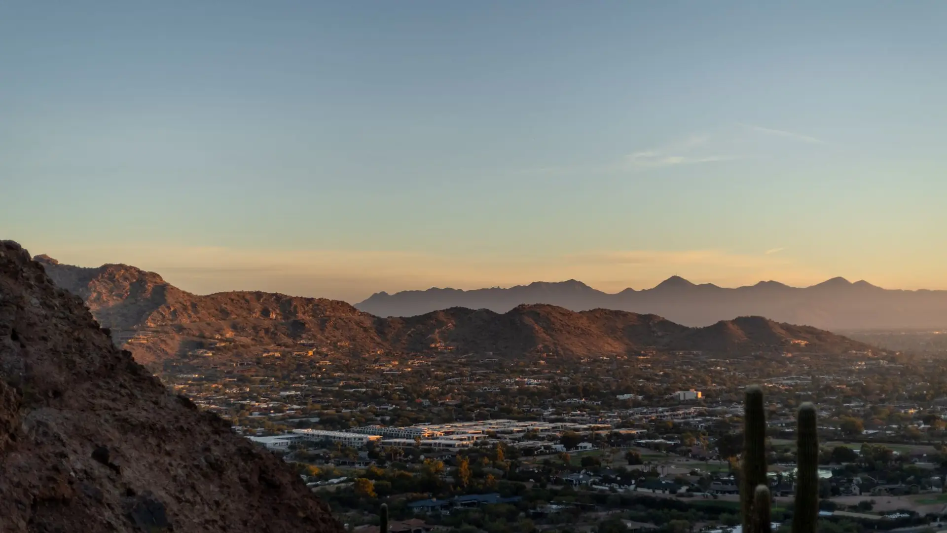Phoenix skyline against desert mountains at dusk